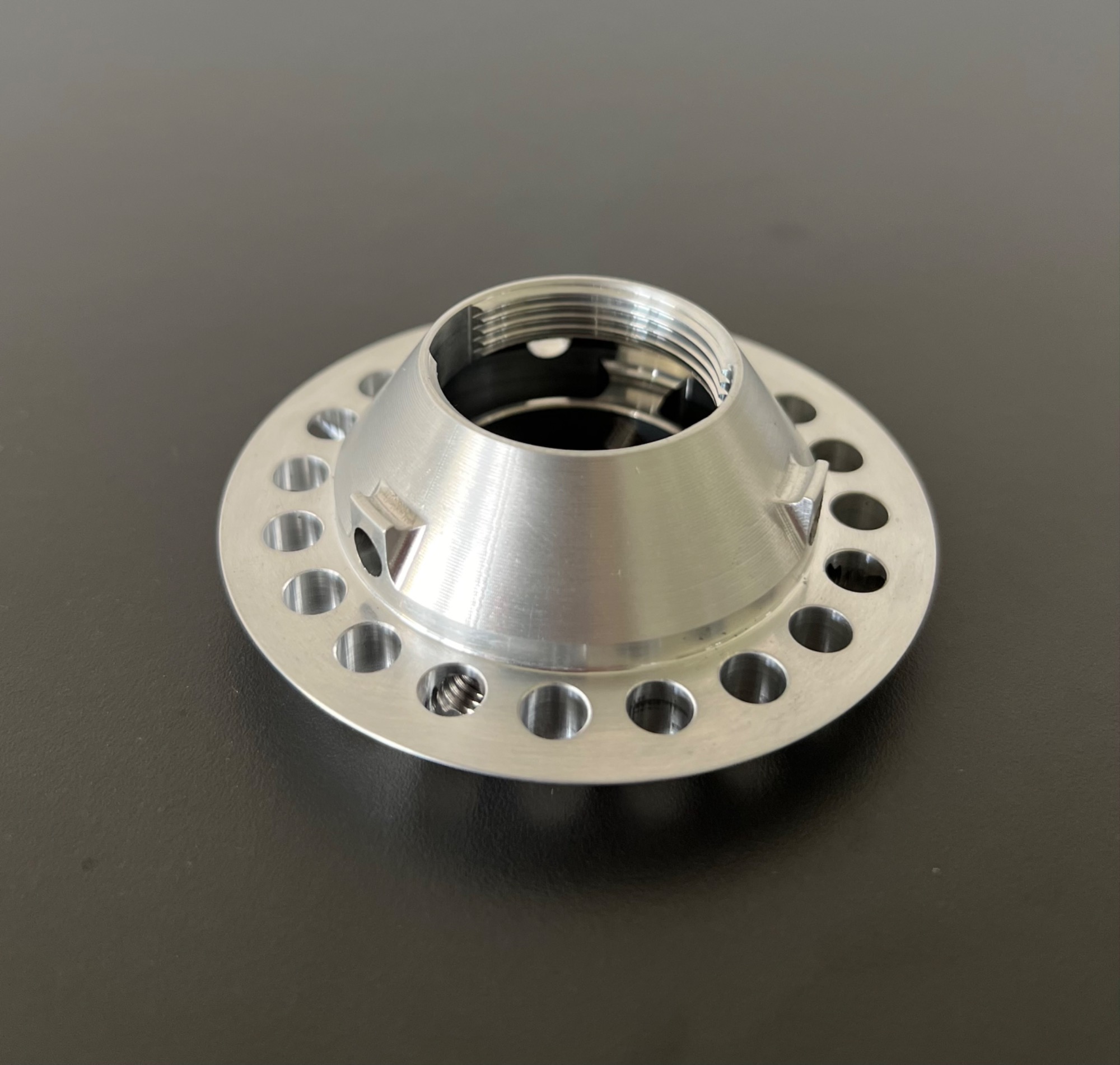 Turned aluminium part with drilling pattern